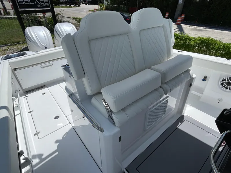 Slide: The Image of 2025 Everglades 315 Center Console boat with white cushioned seating and dual engines. - 36
