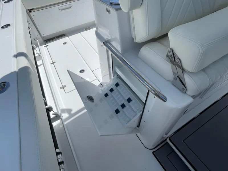 Slide: The Image of 2025 Everglades 315 Center Console boat with open storage compartment and white seating. - 37