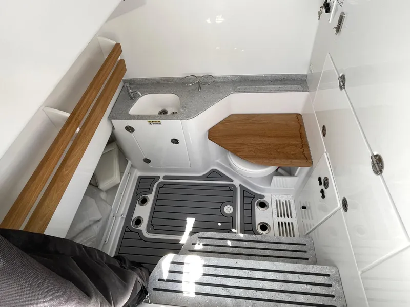 Slide: The Image of 2025 Everglades 315 Center Console interior with sink, wooden accents, and modern design. - 43