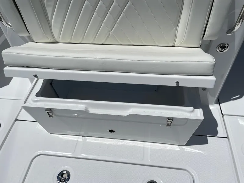 Slide: The Image of 2025 Everglades 315 Center Console boat seat with open storage compartment. - 45