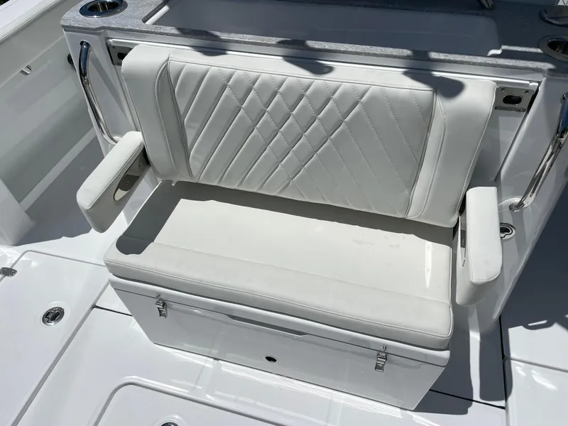 Slide: The Image of 2025 Everglades 315 Center Console boat seat with white cushioned upholstery. - 46