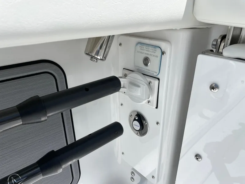 Slide: The Image of Control panel on 2025 Everglades 315 Center Console boat, featuring switches and rod holders. - 49