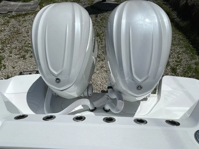 Slide: The Image of 2025 Everglades 315 Center Console boat with dual outboard engines, rear view. - 9