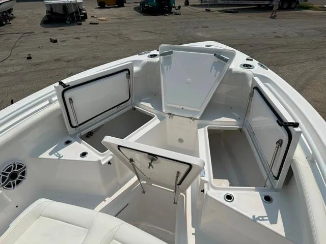 Slide: The Image of 2023 Everglades 235CC boat with open storage compartments on deck. - 10