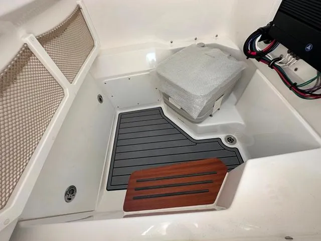 Slide: The Image of 2023 Everglades 235CC boat interior with storage, seating, and wiring details. - 14