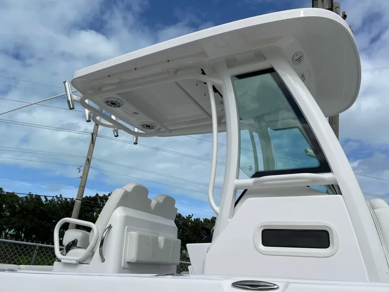 Slide: The Image of 2023 Everglades 235CC boat with sleek design and modern features under a blue sky. - 17