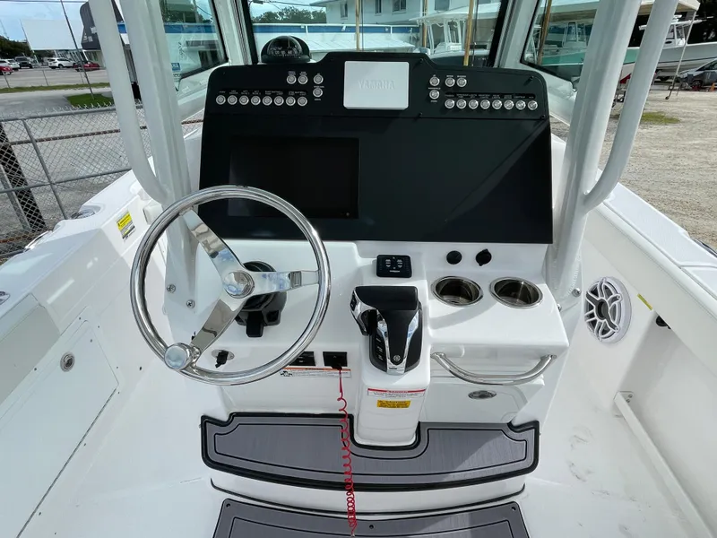 Slide: The Image of 2023 Everglades 235CC boat console with steering wheel and control panel. - 18