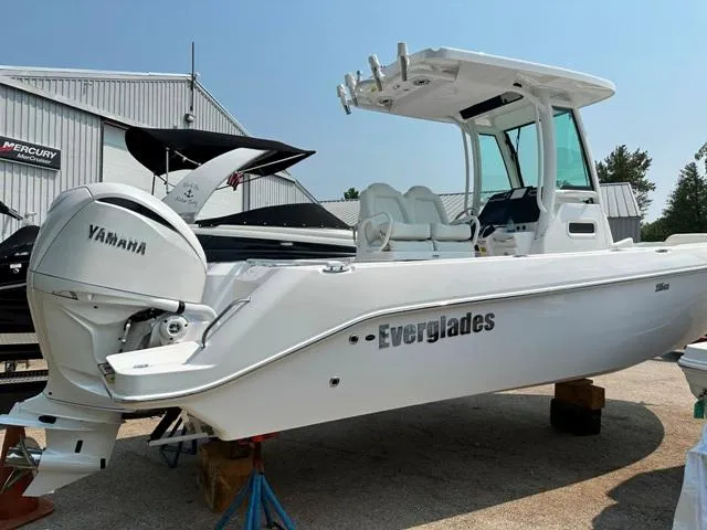 Slide: The Image of 2023 Everglades 235CC boat with Yamaha engine, displayed outdoors. - 2