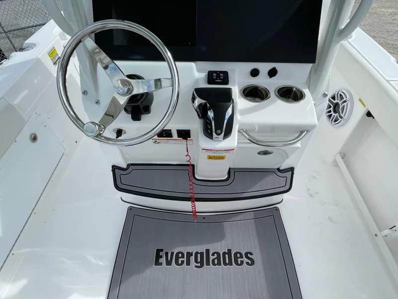 Slide: The Image of 2023 Everglades 235CC boat helm with steering wheel and controls. - 20