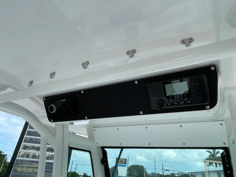 Slide: The Image of 2023 Everglades 235CC boat interior with electronic control panel and radio system. - 21