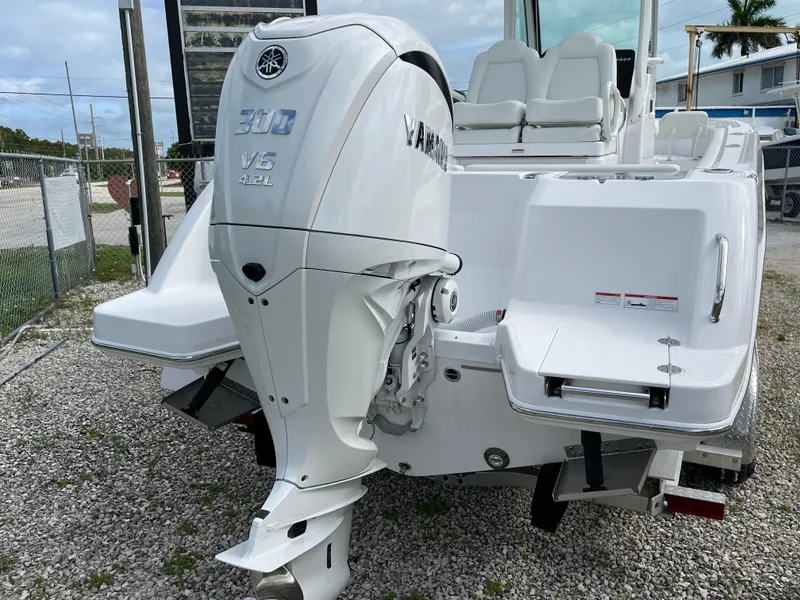 Slide: The Image of 2023 Everglades 235CC boat with Yamaha V6 300 outboard engine, parked on gravel. - 25