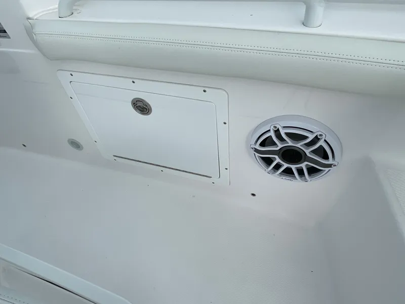 Slide: The Image of 2023 Everglades 235CC boat interior with speaker and storage compartment. - 27