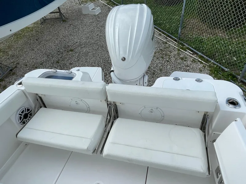 Slide: The Image of 2023 Everglades 235CC boat with white seating and outboard motor, viewed from above. - 29