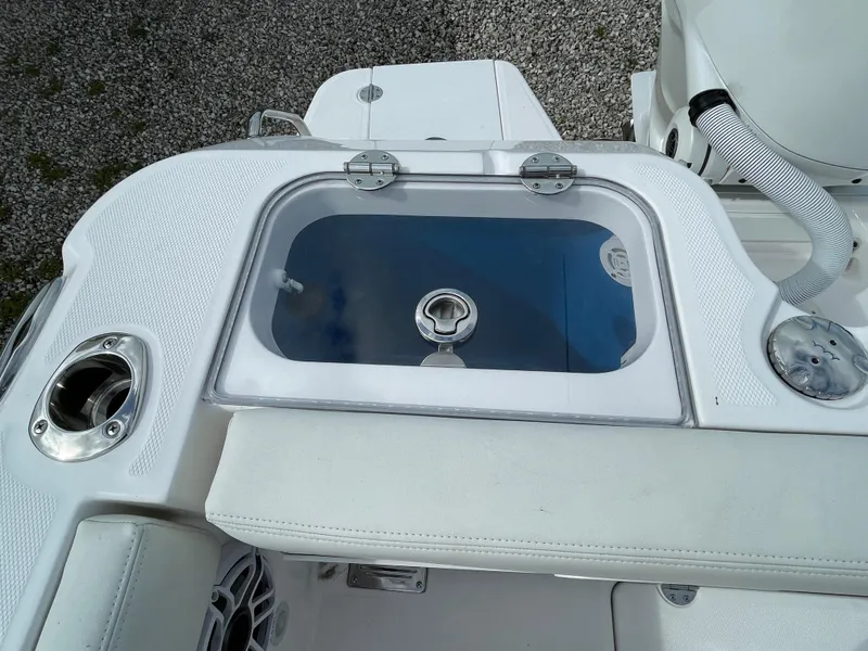 Slide: The Image of 2023 Everglades 235CC boat livewell with white seating and stainless steel fixtures. - 30