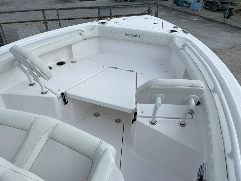 Slide: The Image of 2023 Everglades 235CC boat interior with white seating and deck, showcasing modern design. - 9