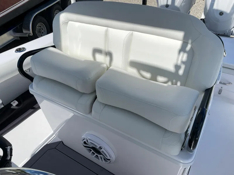 Slide: The Image of 2023 Everglades 273CC boat seating with white cushions and speaker. - 13