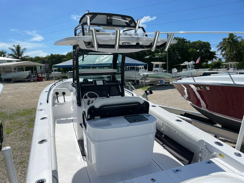 Slide: The Image of 2023 Everglades 273CC boat with center console and T-top, displayed outdoors. - 18