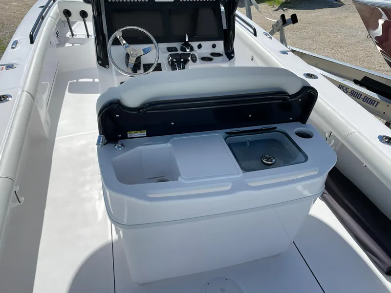 Slide: The Image of 2023 Everglades 273CC boat interior with steering console and seating area. - 22