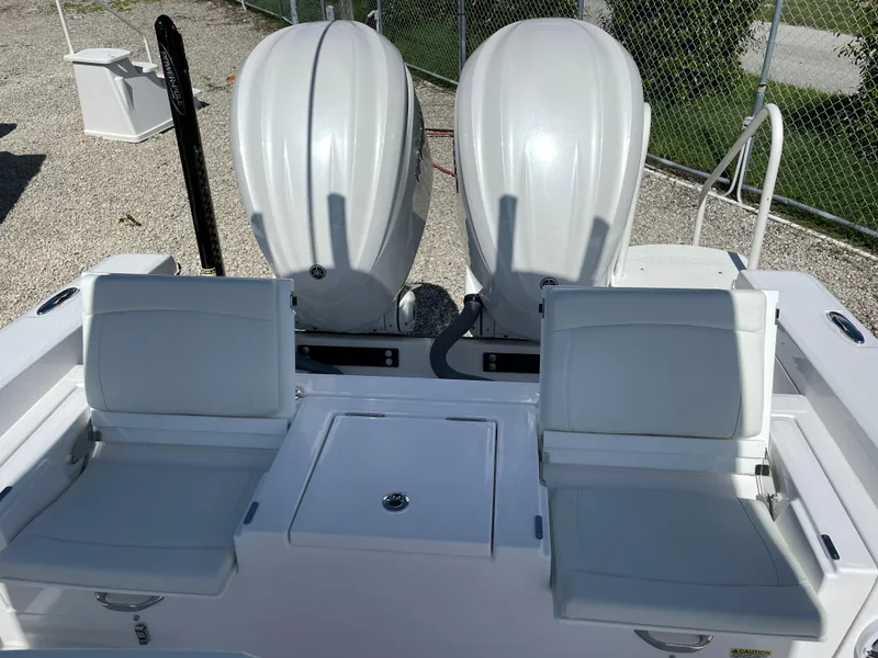 Slide: The Image of 2023 Everglades 273CC boat with dual outboard engines and white seating. - 23
