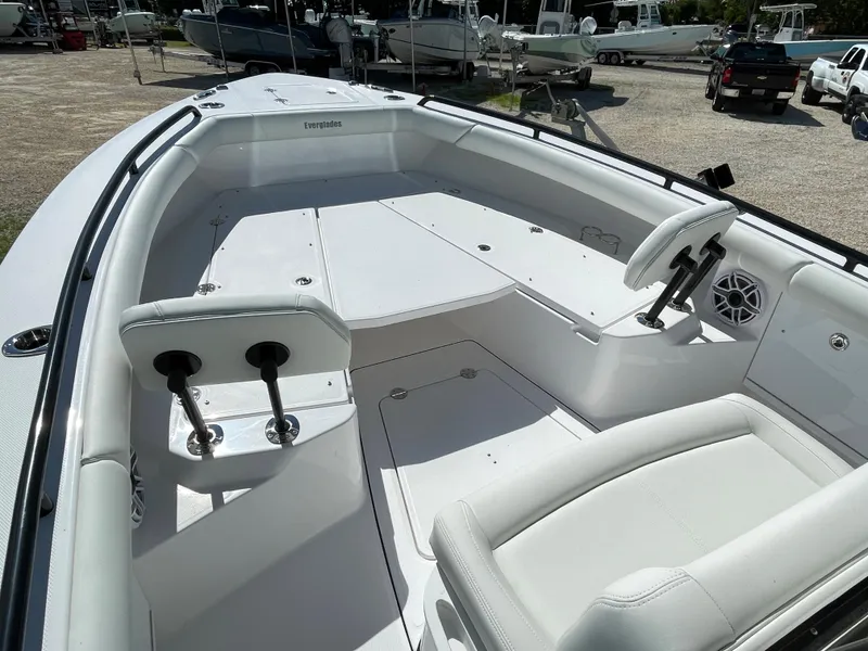 Slide: The Image of 2023 Everglades 273CC boat interior with white seating and deck, featuring modern design elements. - 5