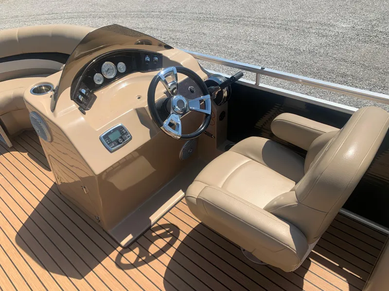 Slide: The Image of 2014 Harris FloteBote 200 Cruiser CS boat interior with steering console and beige seating. - 12