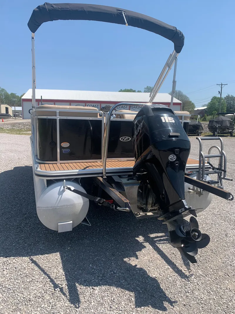 Slide: The Image of 2014 Harris FloteBote 200 Cruiser CS pontoon boat with outboard motor, parked on gravel. - 21