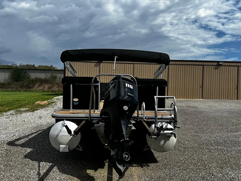 Slide: The Image of 2014 Harris FloteBote 200 Cruiser CS pontoon boat with outboard motor, parked on gravel. - 4
