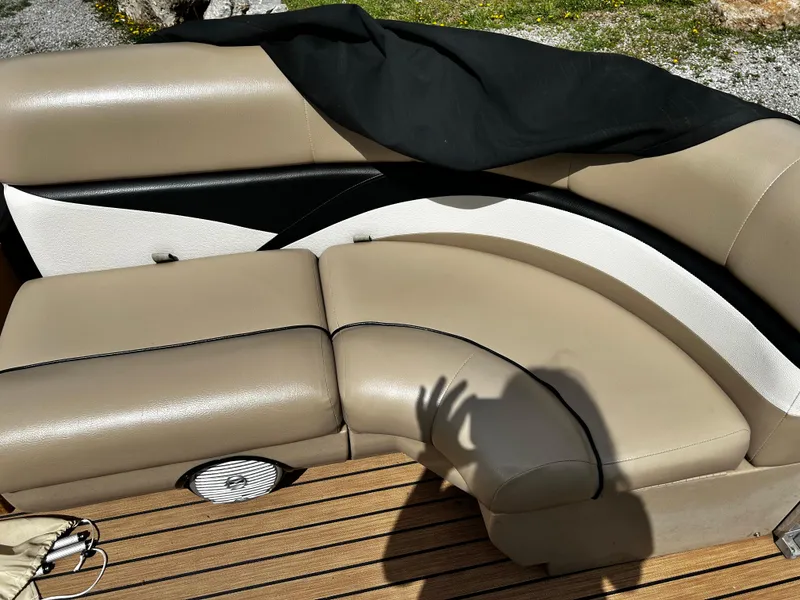 Slide: The Image of 2014 Harris FloteBote 200 Cruiser CS boat seating with beige upholstery and wood deck. - 8