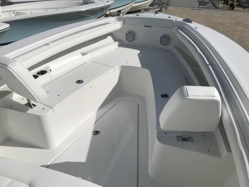 Slide: The Image of 2023 Regulator 23 boat interior with white seating and storage compartments. - 11