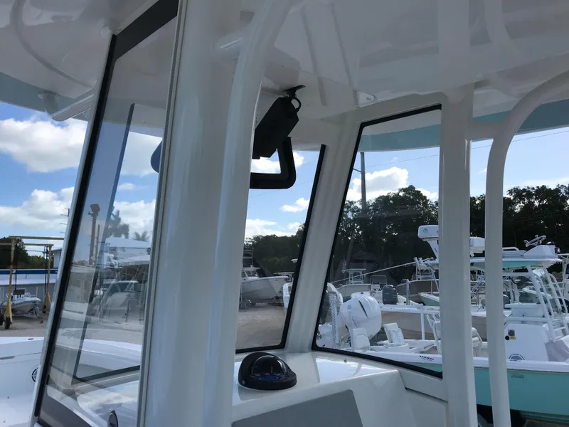 Slide: The Image of 2023 Regulator 23 boat interior with clear windows and outdoor view. - 17