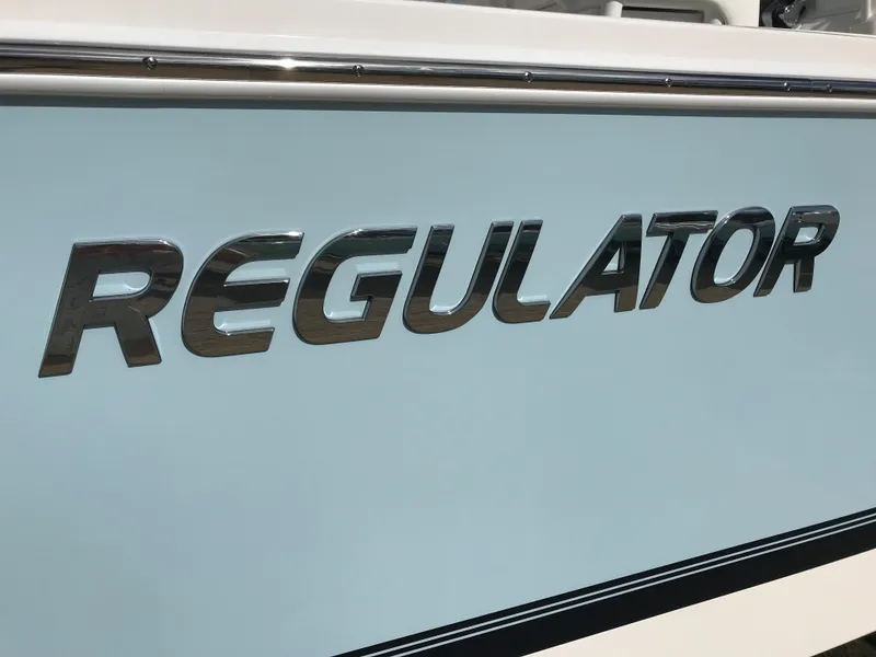 Slide: The Image of 2023 Regulator 23 boat logo on light blue hull. - 2
