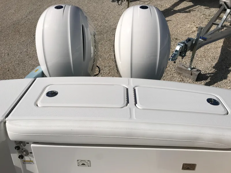 Slide: The Image of 2023 Regulator 23 boat with dual outboard engines, viewed from the rear. - 20