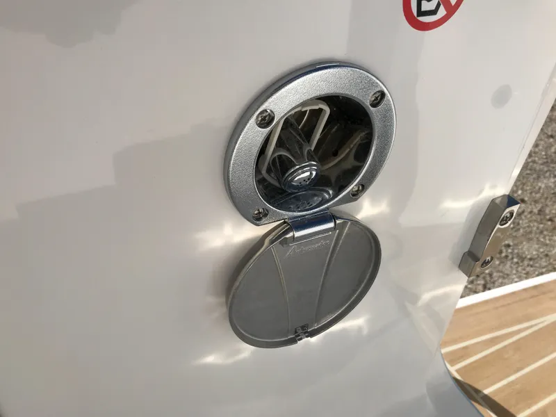 Slide: The Image of Fuel cap on 2023 Regulator 23 boat, open with visible interior components. - 21
