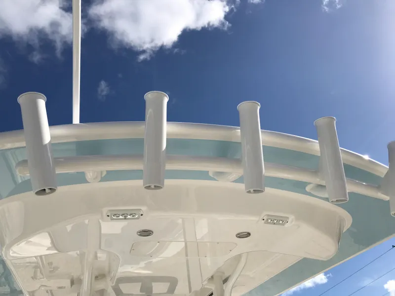 Slide: The Image of 2023 Regulator 23 boat with rod holders against a clear blue sky. - 24