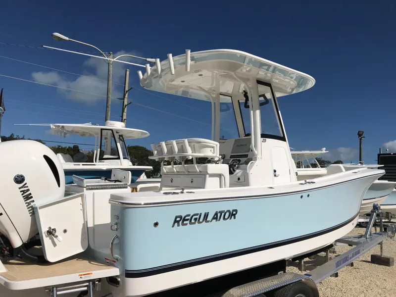Slide: The Image of 2023 Regulator 23 boat with Yamaha engine, displayed on a trailer under clear blue sky. - 25