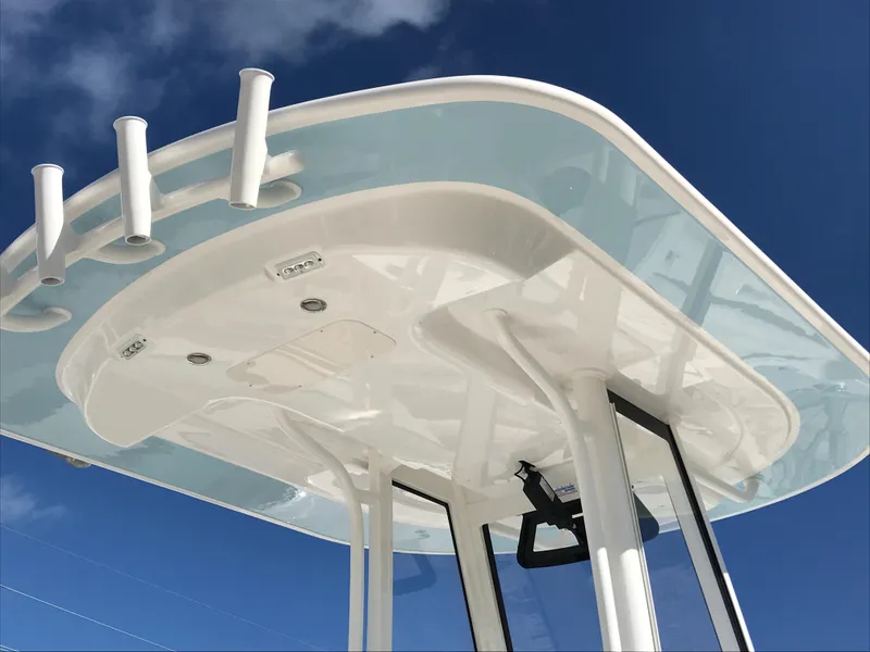 Slide: The Image of 2023 Regulator 23 boat T-top against a clear blue sky. - 27