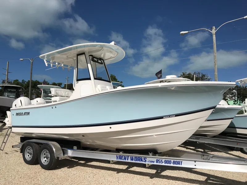 Slide: The Image of 2023 Regulator 23 boat on trailer under clear blue sky. - 4