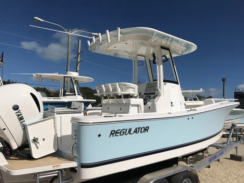 Slide: The Image of 2023 Regulator 23 boat with Yamaha engine, displayed on a trailer under clear blue sky. - 5