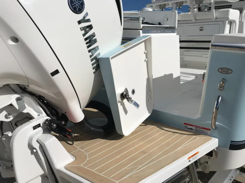 Slide: The Image of 2023 Regulator 23 boat with Yamaha engine, featuring a rear storage compartment and teak deck. - 7