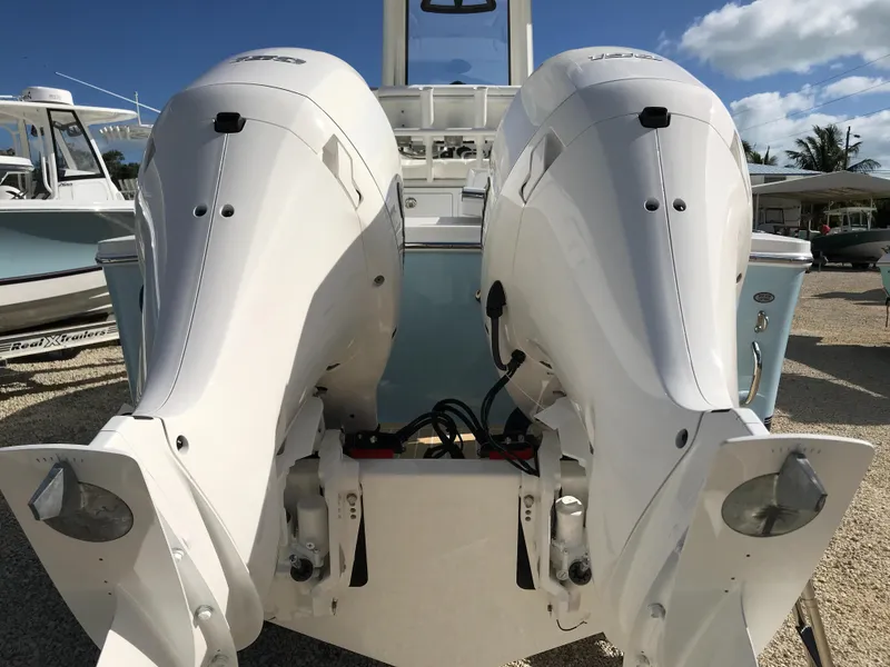 Slide: The Image of 2023 Regulator 23 boat with dual outboard engines, displayed outdoors. - 8