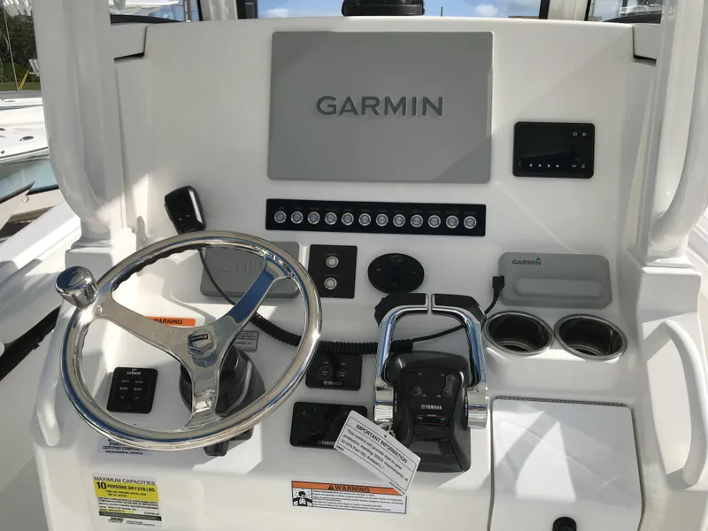 Slide: The Image of 2023 Regulator 23 boat dashboard with Garmin navigation system and steering wheel. - 9