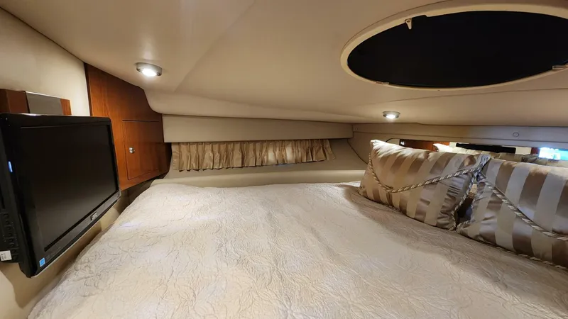 Slide: The Image of 2006 Regal Commodore 3560 IB cabin interior with bed, TV, and ambient lighting. - 10