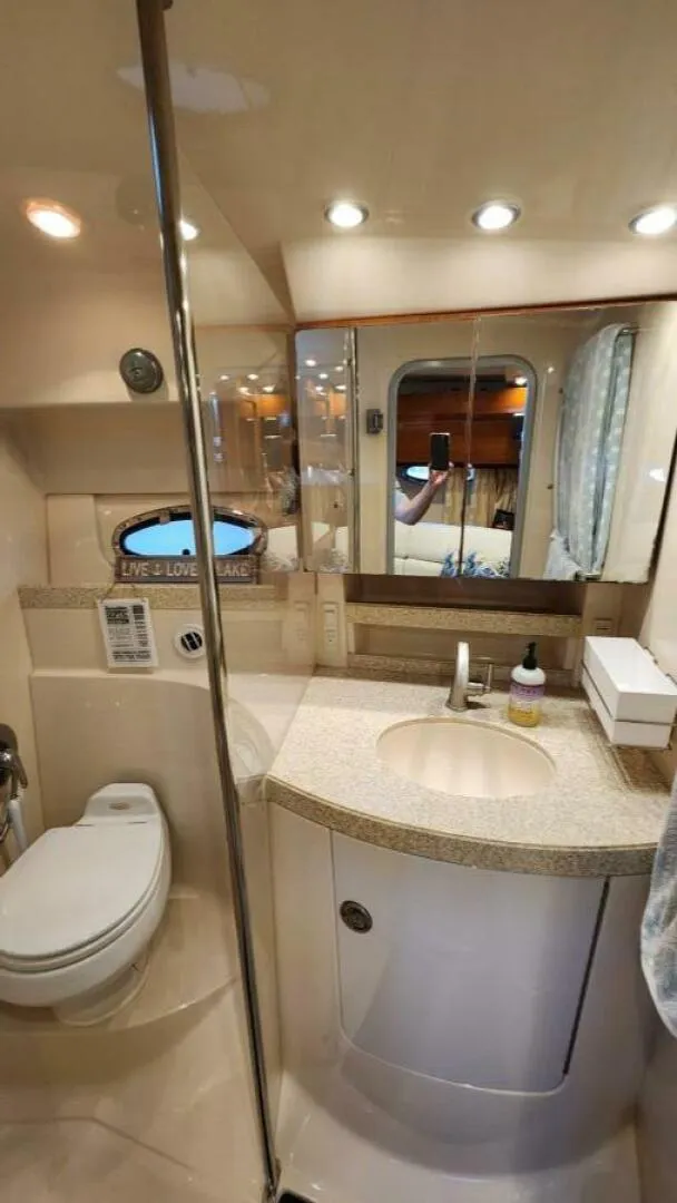 Slide: The Image of Bathroom interior of 2006 Regal Commodore 3560 IB yacht, featuring modern fixtures and lighting. - 11