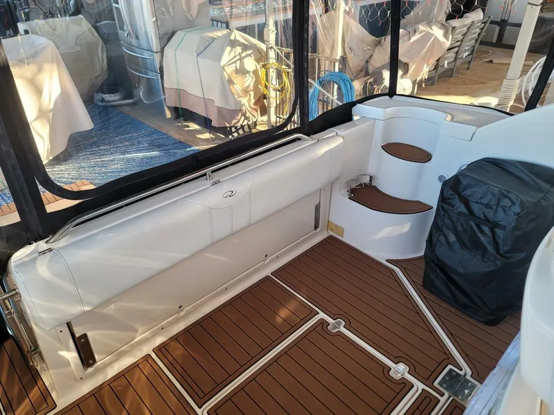 Slide: The Image of 2006 Regal Commodore 3560 IB boat interior with teak flooring and seating area. - 13