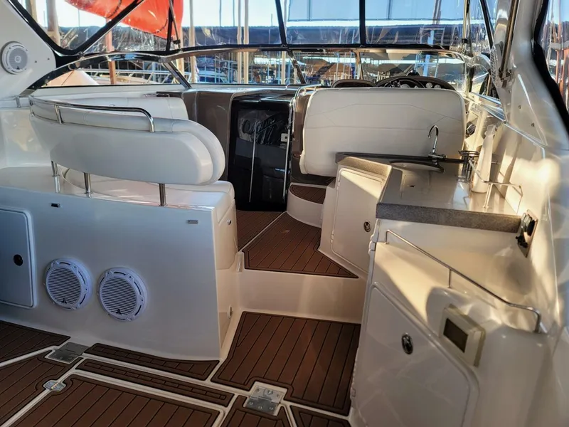 Slide: The Image of 2006 Regal Commodore 3560 IB boat interior with seating and wooden flooring. - 14