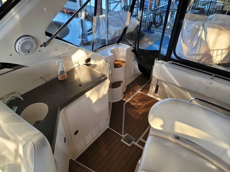 Slide: The Image of 2006 Regal Commodore 3560 IB yacht interior with seating and kitchenette. - 15