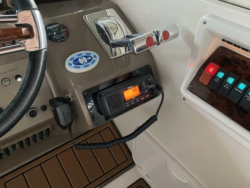 Slide: The Image of Control panel of a 2006 Regal Commodore 3560 IB boat with radio and switches. - 18