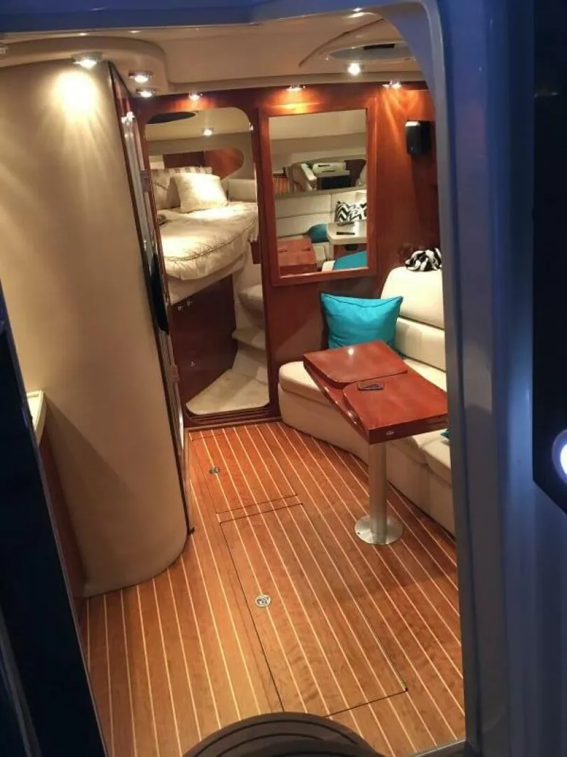 Slide: The Image of 2006 Regal Commodore 3560 IB cabin interior with wood flooring and cozy seating area. - 2