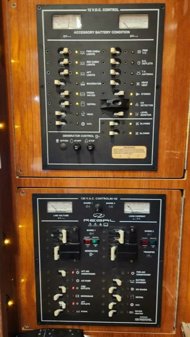 Slide: The Image of Control panel of a 2006 Regal Commodore 3560 IB boat, featuring switches and meters. - 20