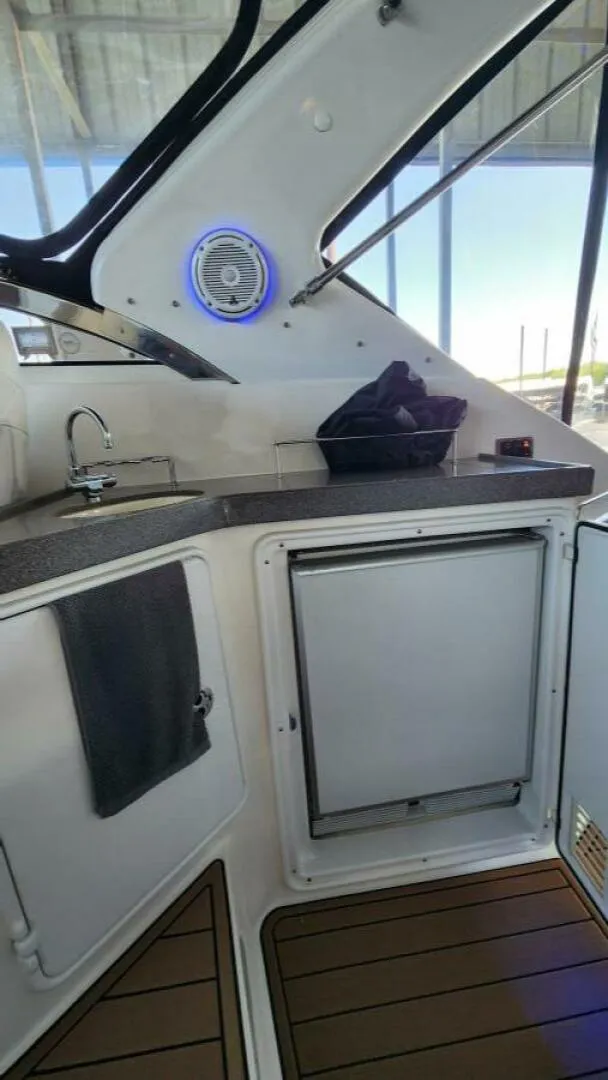 Slide: The Image of 2006 Regal Commodore 3560 IB yacht interior with kitchenette and modern amenities. - 21